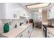 Modern kitchen with white cabinets and a view of the dining area at 4140 N 81St St, Scottsdale, AZ 85251