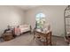 Bright bedroom with a daybed, desk, and ample natural light at 41925 W Arvada Ln, Maricopa, AZ 85138