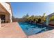 Inviting backyard swimming pool with water features and ample patio space at 41925 W Arvada Ln, Maricopa, AZ 85138