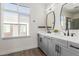 Modern bathroom with gray double vanity, large mirror, and walk-in shower at 4444 N 25Th St # 1, Phoenix, AZ 85016