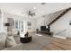 Bright living room featuring modern furnishings, a large rug, and a staircase with metal railing at 4444 N 25Th St # 1, Phoenix, AZ 85016