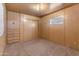 Simple bedroom with wood paneling, built-in drawers and closet at 530 S Alma School Rd # 75, Mesa, AZ 85210