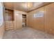 Simple bedroom with wood paneling, built-in drawers and closet at 530 S Alma School Rd # 75, Mesa, AZ 85210