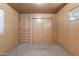 Simple bedroom with wood paneling, built-in drawers and closet at 530 S Alma School Rd # 75, Mesa, AZ 85210