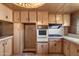 Retro kitchen features wood cabinets, built-in oven, and gas cooktop at 530 S Alma School Rd # 75, Mesa, AZ 85210