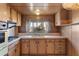 Kitchen features wood cabinets and a double sink at 530 S Alma School Rd # 75, Mesa, AZ 85210