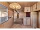 View of kitchen and living area with wood cabinets and flooring at 530 S Alma School Rd # 75, Mesa, AZ 85210