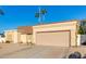 Tan house with a two-car garage and gravel driveway at 5448 W Shaw Butte Dr, Glendale, AZ 85304