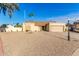 Tan house with a two-car garage and gravel driveway at 5448 W Shaw Butte Dr, Glendale, AZ 85304