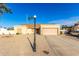 Tan house with a two-car garage and gravel driveway at 5448 W Shaw Butte Dr, Glendale, AZ 85304