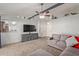 Living room features a gray sectional sofa and a large TV at 5448 W Shaw Butte Dr, Glendale, AZ 85304