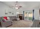 Living room with gray sectional sofa and access to backyard at 5448 W Shaw Butte Dr, Glendale, AZ 85304