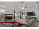 Living room with gray sectional sofa, fireplace, and sliding door at 5448 W Shaw Butte Dr, Glendale, AZ 85304