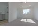 Bright bedroom featuring neutral carpet, a window and an en suite bathroom at 5725 W Osborn Rd, Phoenix, AZ 85031