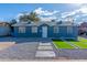 Charming blue home featuring manicured gravel landscaping and decorative patches of artificial turf at 5725 W Osborn Rd, Phoenix, AZ 85031