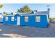 Charming blue home featuring manicured gravel landscaping and decorative patches of artificial turf at 5725 W Osborn Rd, Phoenix, AZ 85031