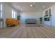 Open-concept living room featuring white walls, a ceiling fan, and modern furniture at 5725 W Osborn Rd, Phoenix, AZ 85031