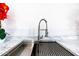 Close-up of a stainless steel kitchen sink with a modern faucet at 5725 W Osborn Rd, Phoenix, AZ 85031