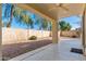 Covered backyard patio with a ceiling fan offers a shaded space for relaxation and entertaining at 60 W Beechnut Pl, Chandler, AZ 85248