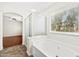 Bright bathroom showcasing a tub with glass door, adjacent to a window offering natural light at 60 W Beechnut Pl, Chandler, AZ 85248