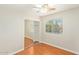 Bedroom featuring hardwood floors, a ceiling fan, a window, and a closet at 60 W Beechnut Pl, Chandler, AZ 85248