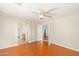 Bright bedroom featuring hardwood floors, a ceiling fan, and an open layout at 60 W Beechnut Pl, Chandler, AZ 85248