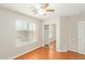 Bedroom featuring hardwood floors, a ceiling fan, window, and a closet at 60 W Beechnut Pl, Chandler, AZ 85248