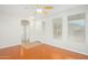 Bright living room featuring wood-look floors, a ceiling fan, and abundant natural light at 60 W Beechnut Pl, Chandler, AZ 85248