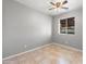 Bright bedroom with gray walls, tile floors, and a ceiling fan at 6302 N 64Th Dr # 4, Glendale, AZ 85301