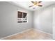 Bedroom with gray walls, tile floor, ceiling fan and window at 6302 N 64Th Dr # 4, Glendale, AZ 85301