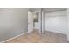 Simple bedroom with gray walls, tile floors, and a closet at 6302 N 64Th Dr # 4, Glendale, AZ 85301