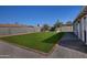 Landscaped backyard with green lawn and gravel at 6334 W Vogel Ave, Glendale, AZ 85302