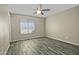 Bright bedroom with ceiling fan and wood-look tile floor at 6334 W Vogel Ave, Glendale, AZ 85302