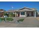 Charming ranch home with red doors and a well-maintained lawn at 6334 W Vogel Ave, Glendale, AZ 85302