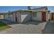 Rear house view, showing a red door and gravel landscaping at 6334 W Vogel Ave, Glendale, AZ 85302