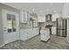 White kitchen with island, stainless steel appliances, and grey tile floor at 6334 W Vogel Ave, Glendale, AZ 85302