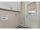 Bright laundry room with white cabinets and tiled floor at 6334 W Vogel Ave, Glendale, AZ 85302