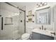 Updated bathroom with walk-in shower, modern vanity, and floating shelves at 6611 N 181St Ave, Waddell, AZ 85355