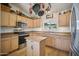 Modern kitchen with stainless steel appliances and an island at 6611 N 181St Ave, Waddell, AZ 85355