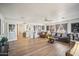 Living room with hardwood floors, sofas, and a view of the kitchen at 6611 N 181St Ave, Waddell, AZ 85355