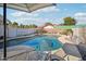 Relaxing kidney-shaped pool with patio furniture nearby at 6611 N 181St Ave, Waddell, AZ 85355