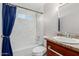 Updated bathroom with new vanity, bathtub, and blue shower curtain at 6936 W Berkeley Rd, Phoenix, AZ 85035