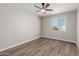 Bright bedroom with ceiling fan and wood-look flooring at 6936 W Berkeley Rd, Phoenix, AZ 85035