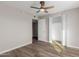 Bedroom with ceiling fan, wood-look flooring, and closet at 6936 W Berkeley Rd, Phoenix, AZ 85035