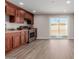 Modern kitchen features wood cabinets, stainless steel appliances, and sliding glass door to backyard at 6936 W Berkeley Rd, Phoenix, AZ 85035