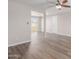 Open concept living room with laminate flooring and neutral walls at 6936 W Berkeley Rd, Phoenix, AZ 85035