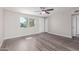 Bright and airy living room with laminate flooring and ceiling fan at 6936 W Berkeley Rd, Phoenix, AZ 85035