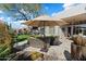 Backyard oasis with circular seating and a large umbrella at 6963 E Bramble Berry Ln, Scottsdale, AZ 85266