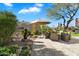 Landscaped backyard with seating area, fountain, and artificial turf at 6963 E Bramble Berry Ln, Scottsdale, AZ 85266