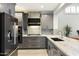 Modern kitchen with gray cabinets and marble countertops at 6963 E Bramble Berry Ln, Scottsdale, AZ 85266